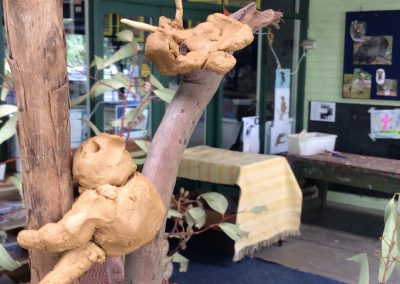 Photo of clay sculptures of koalas in a tree